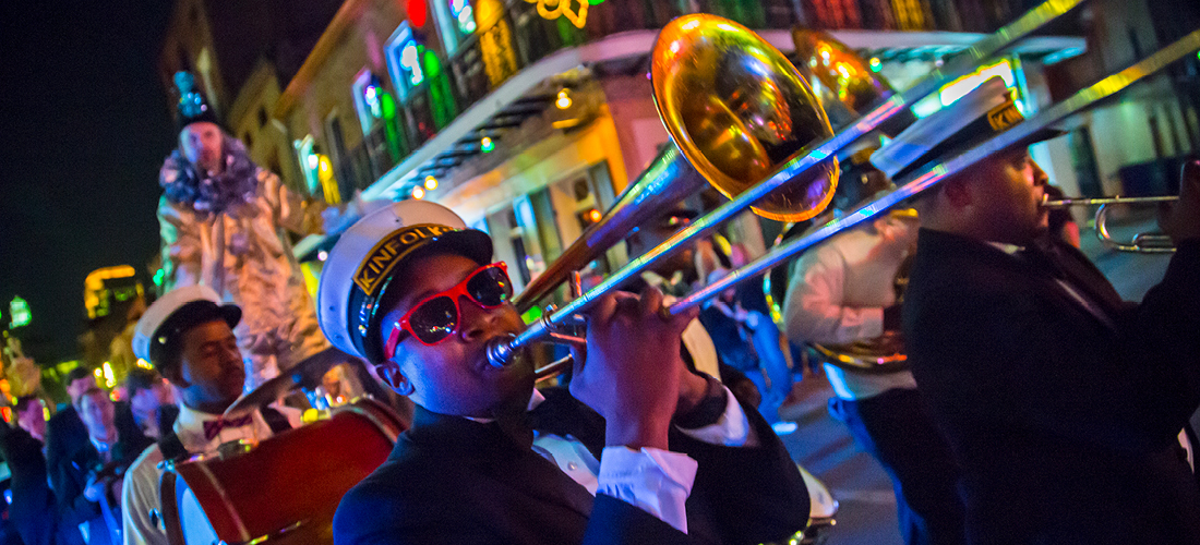 Musician plays trombone in parade.