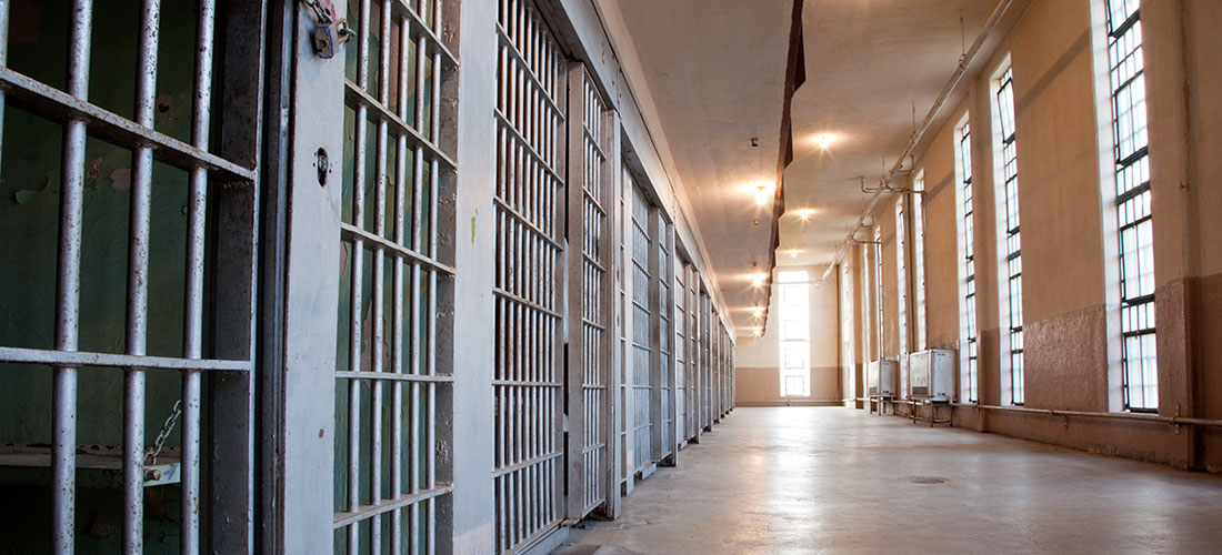 Lit hallway in a prison.