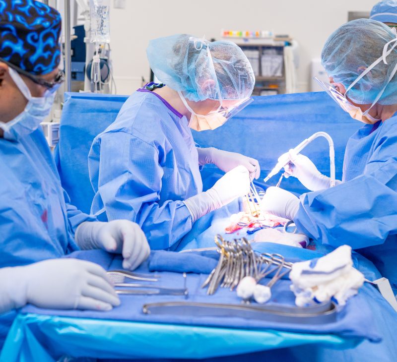 Surgical team works on a patient in an operating room.