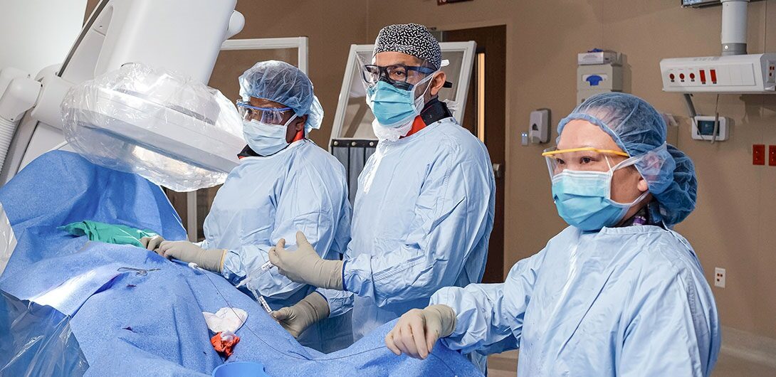 Nurses work on patient during surgery.