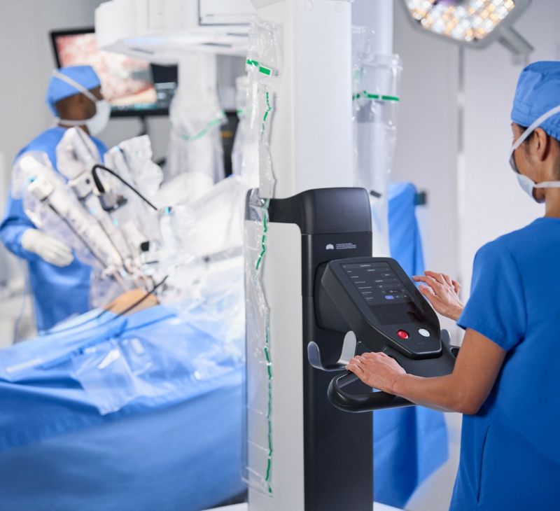 Nurse operating a robotic surgery tool. Nurse operating a robotic surgery tool.