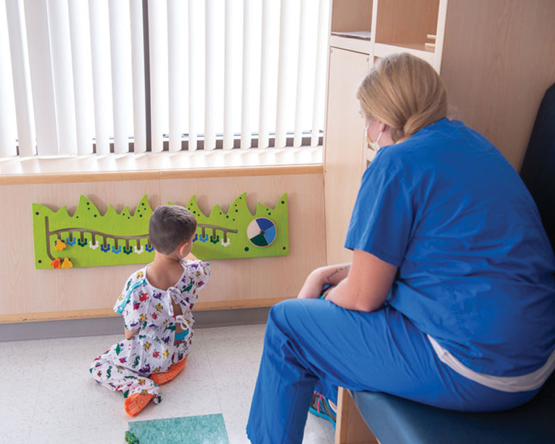 AORN-APSNA-Female-nurse-observing-pediatric-patient Female nurse observing pediatric patient