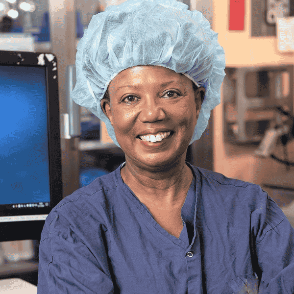 Darlene Murdock in blue scrubs and blue head covering.