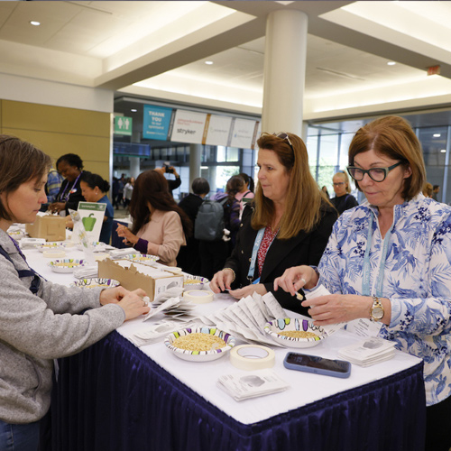 volunteer-activity Attendees pack seeds as part of a volunteer effort.