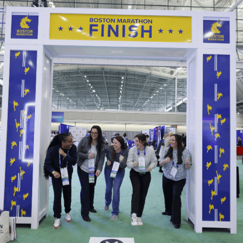 A group of participants smiling at an event wellness space.