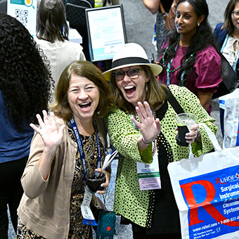 Smiling Expo attendees waving