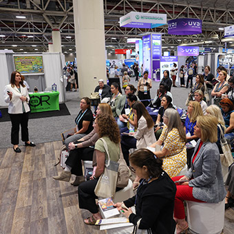 Large group of Expo attendees listening to presenter